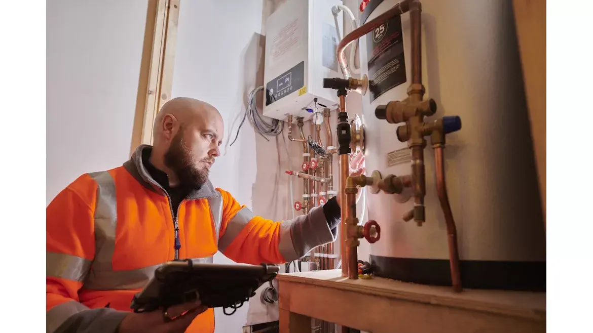 HVAC tech servicing a water heater